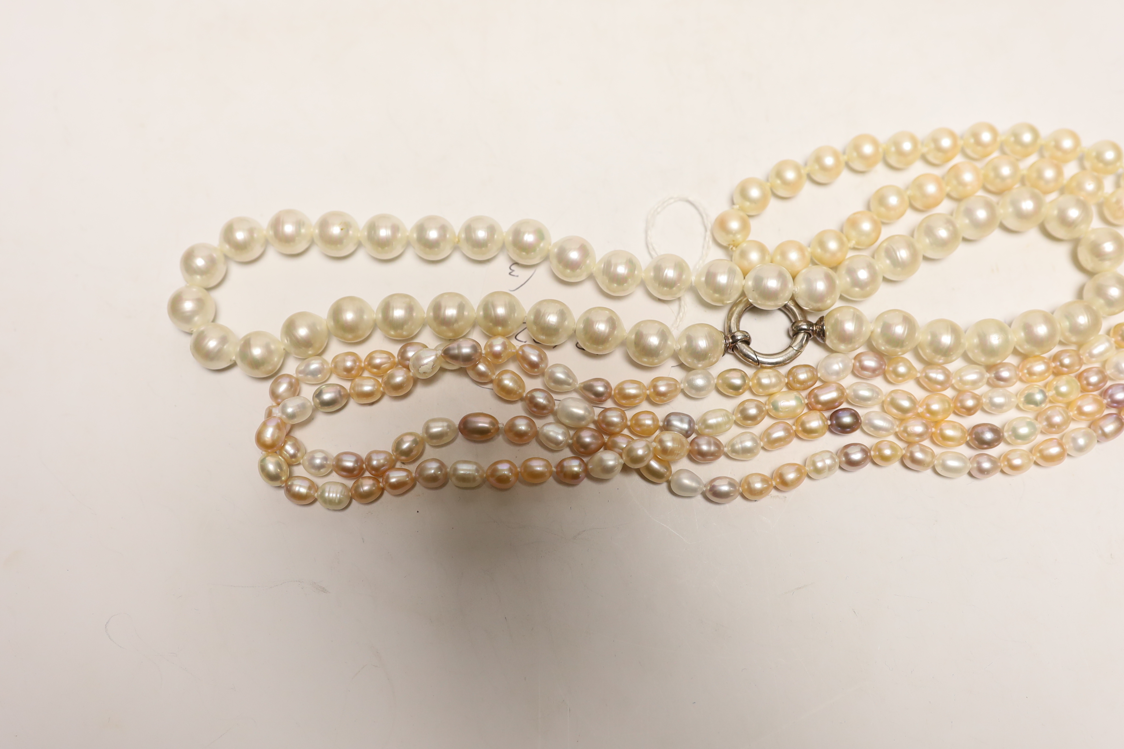 Three assorted single strand cultured South Sea pearl necklaces, largest 136cm.
